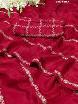 A maroon saree with geometric pattern and pittan work