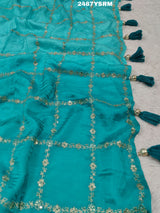 A sea green color saree with geometric pattern and pittan work