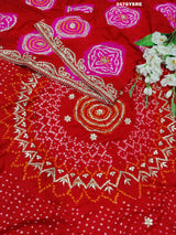 A red Gaji silk saree with Bandhani style embellishments and Gotapatti work