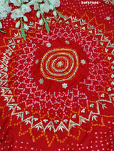 A red Gaji silk saree with Bandhani style embellishments and Gotapatti work
