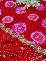 A red Gaji silk saree with Bandhani style embellishments and Gotapatti work