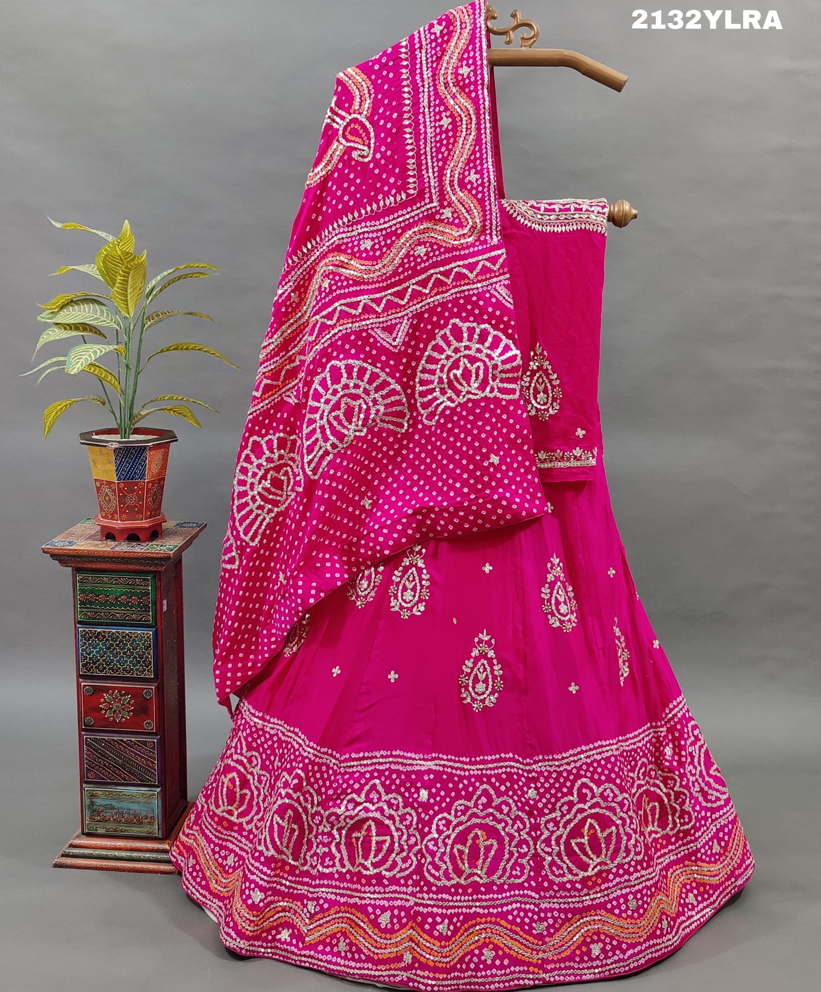 A traditional pink lehanga with bandhani style and gotapatti work