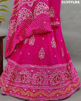 A traditional pink lehanga with bandhani style and gotapatti work