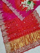 A pink and red Gaji silk saree with Bandhani style Gotapatti work.