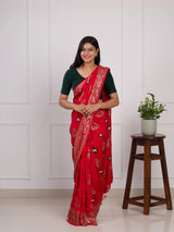 A red saree with green patterns withDola Silk Bandhani Zari Weaving Work 