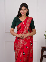 A red saree with green patterns withDola Silk Bandhani Zari Weaving Work 