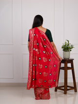 A red saree with green patterns withDola Silk Bandhani Zari Weaving Work 