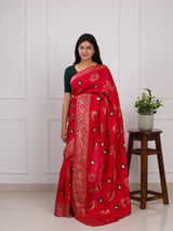 A red saree with green patterns withDola Silk Bandhani Zari Weaving Work 