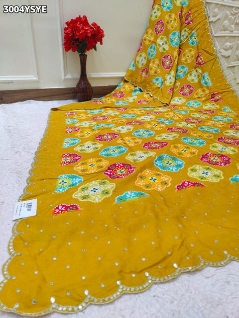 Yellow saree with colorful floral patterns and mirror work
