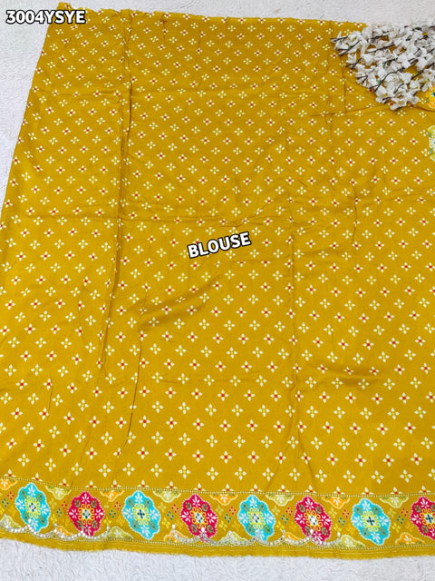 Yellow saree with colorful floral patterns and mirror work