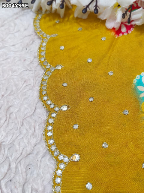 Yellow saree with colorful floral patterns and mirror work