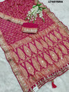 A red and gold saree in rani colour