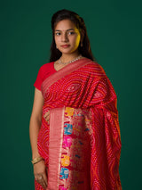 A red munga silk saree with zari border.