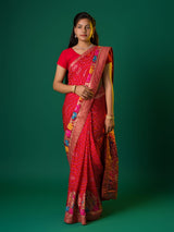 A red munga silk saree with zari border.