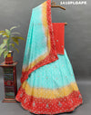 A Lehenga with a multi-color bandhani pattern and cutdana 