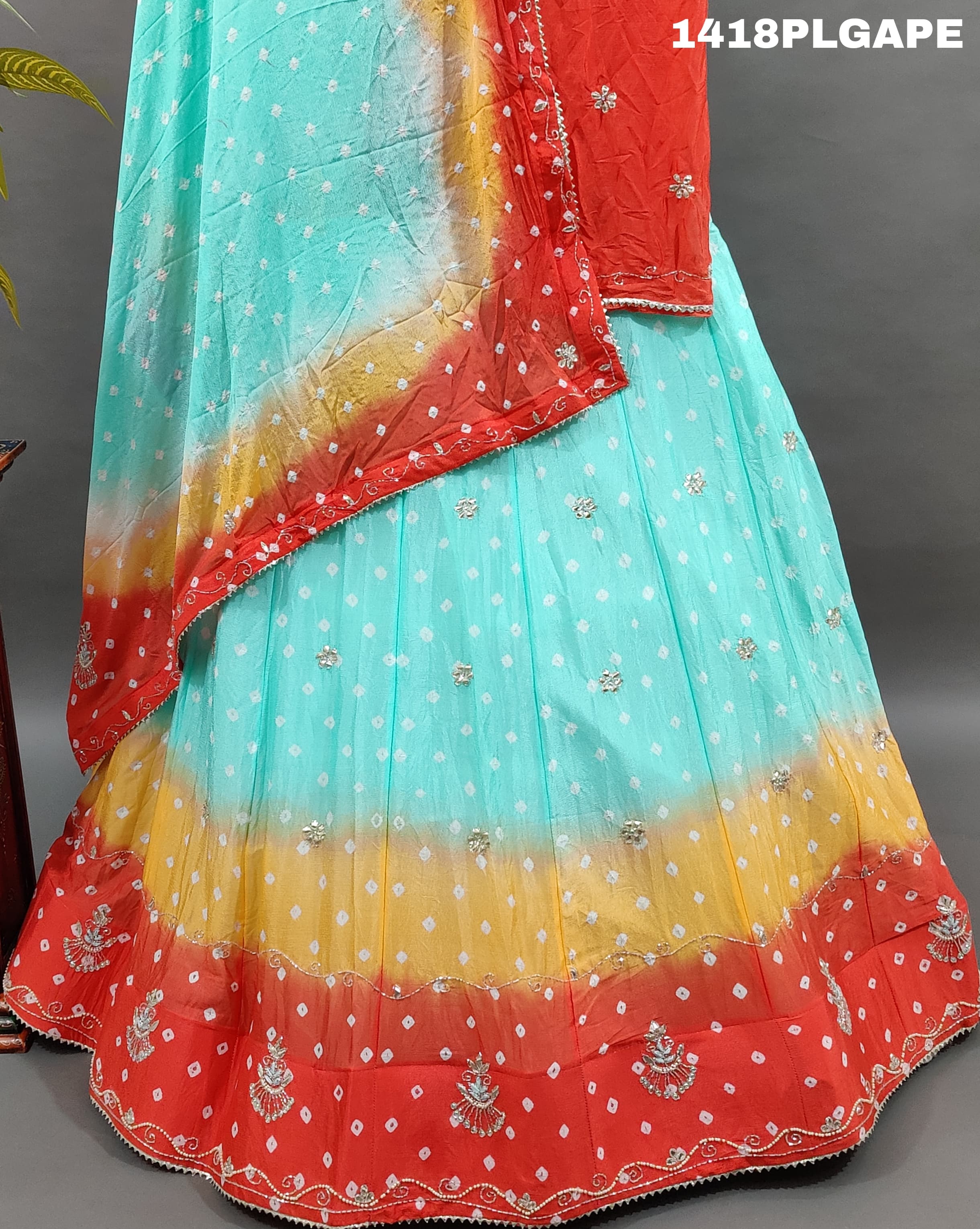 A Lehenga with a multi-color bandhani pattern and cutdana 