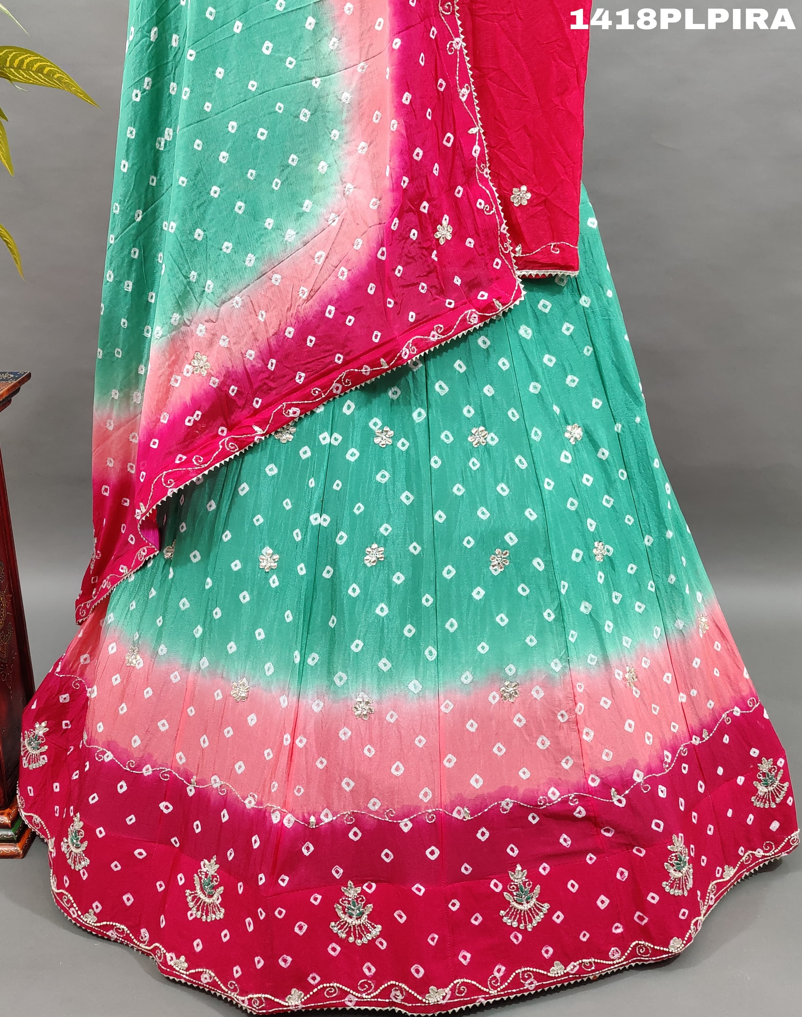 A traditional multicolor bandhani lehenga with cutdana work