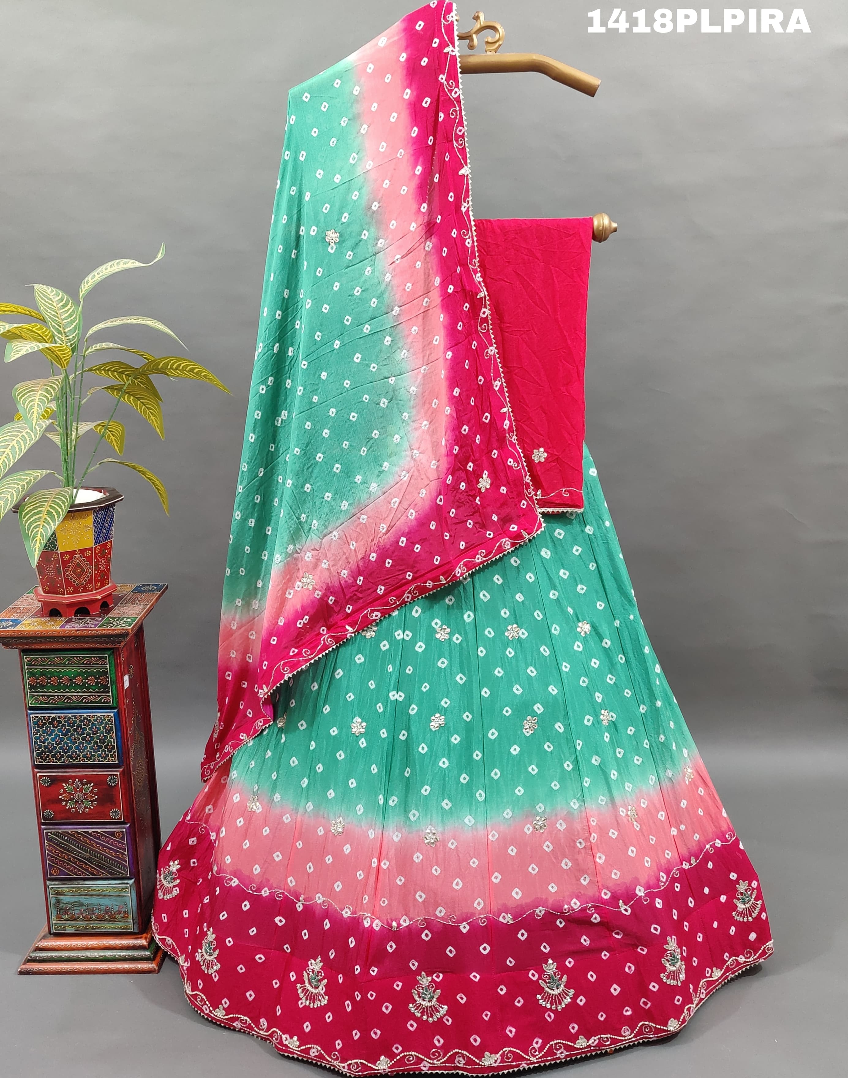 A traditional multicolor bandhani lehenga with cutdana work