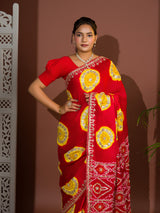 A red saree with bandhej style and gotapatti work in red and yellow colour