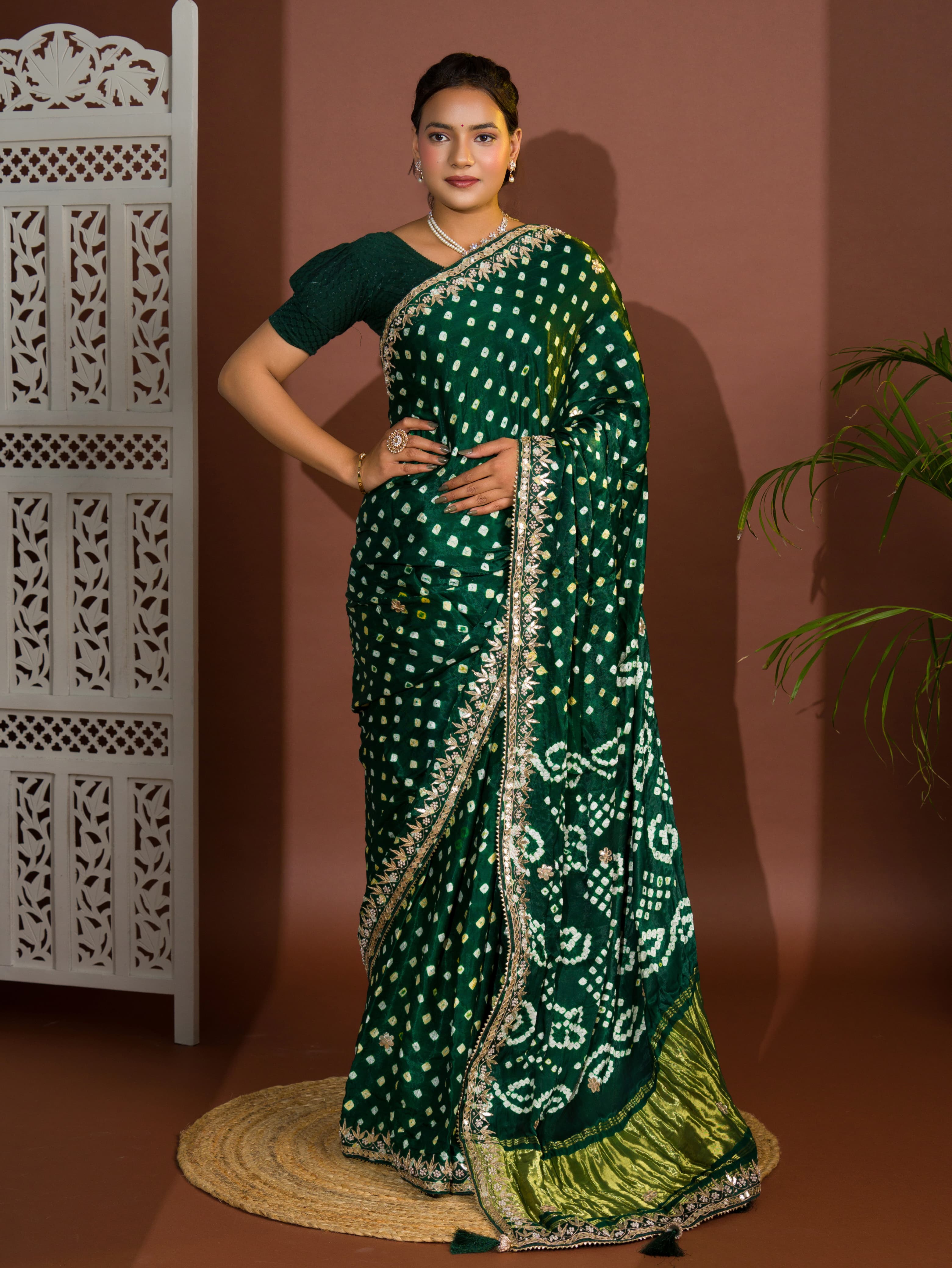 A green saree with bandhej and gotapatti work.