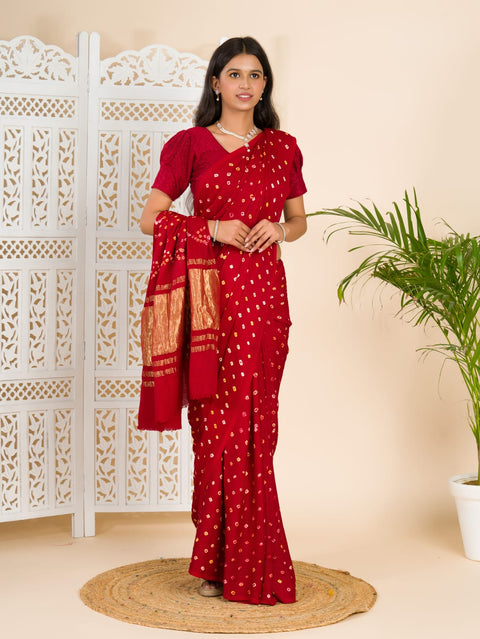 A red and golden bandhani silk saree with a geometric pattern and lagdi patola pallu.
