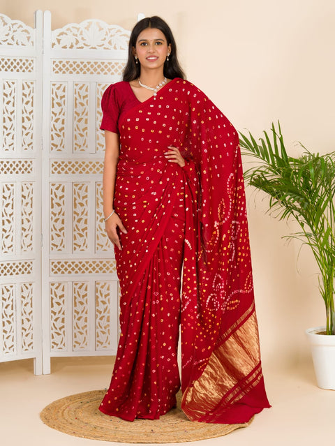 A red and golden bandhani silk saree with a geometric pattern and lagdi pallu.