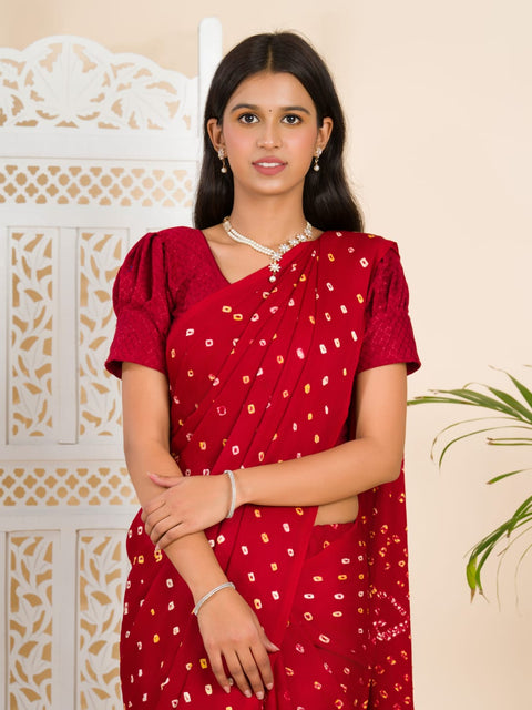A red and golden bandhani silk saree with a geometric pattern and lagdi patola pallu.