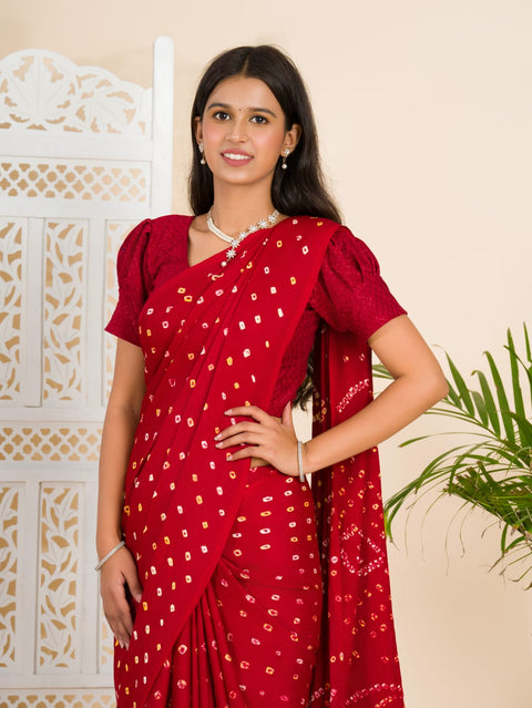 A red and golden bandhani silk saree with a geometric pattern and lagdi patola pallu.