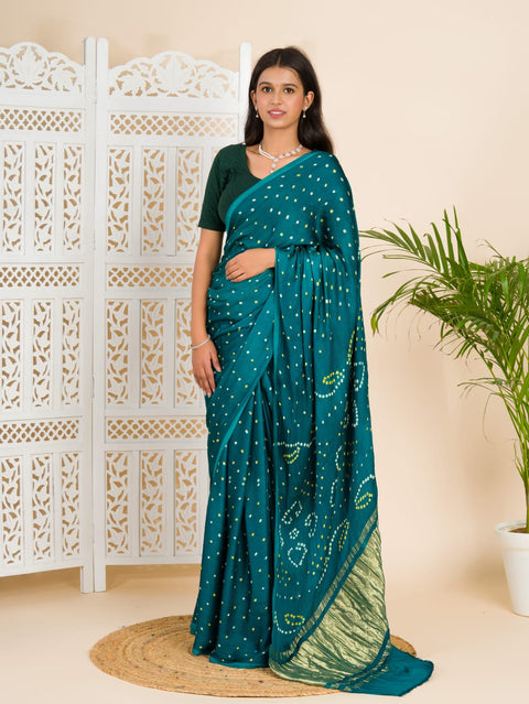  A traditional saree with a bandhani pattern in teal color,