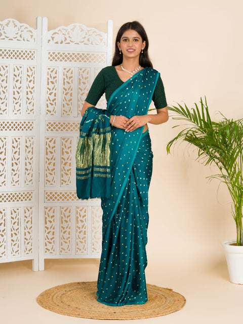  A traditional saree with a bandhani pattern in teal color,