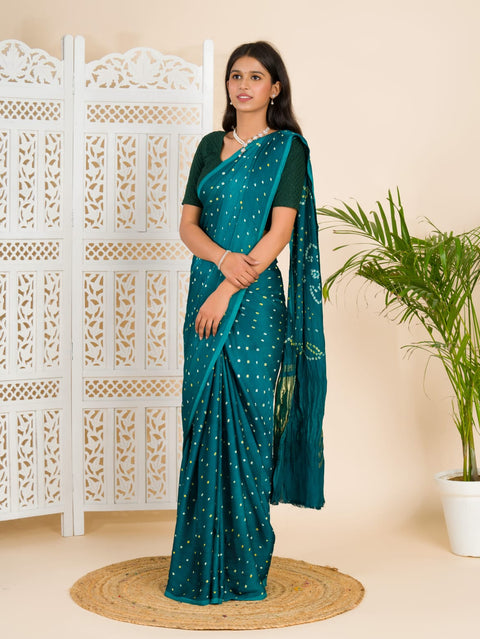  A traditional saree with a bandhani pattern in teal color,
