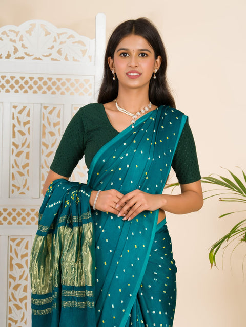 A traditional saree with a bandhani pattern in teal color,