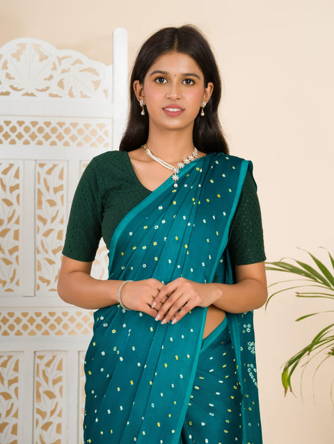  A traditional saree with a bandhani pattern in teal color,