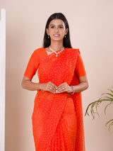 an orange chiffon saree with a bandhani pattern