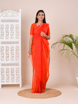 an orange chiffon saree with a bandhani pattern