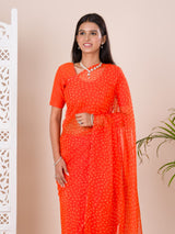 an orange chiffon saree with a bandhani pattern