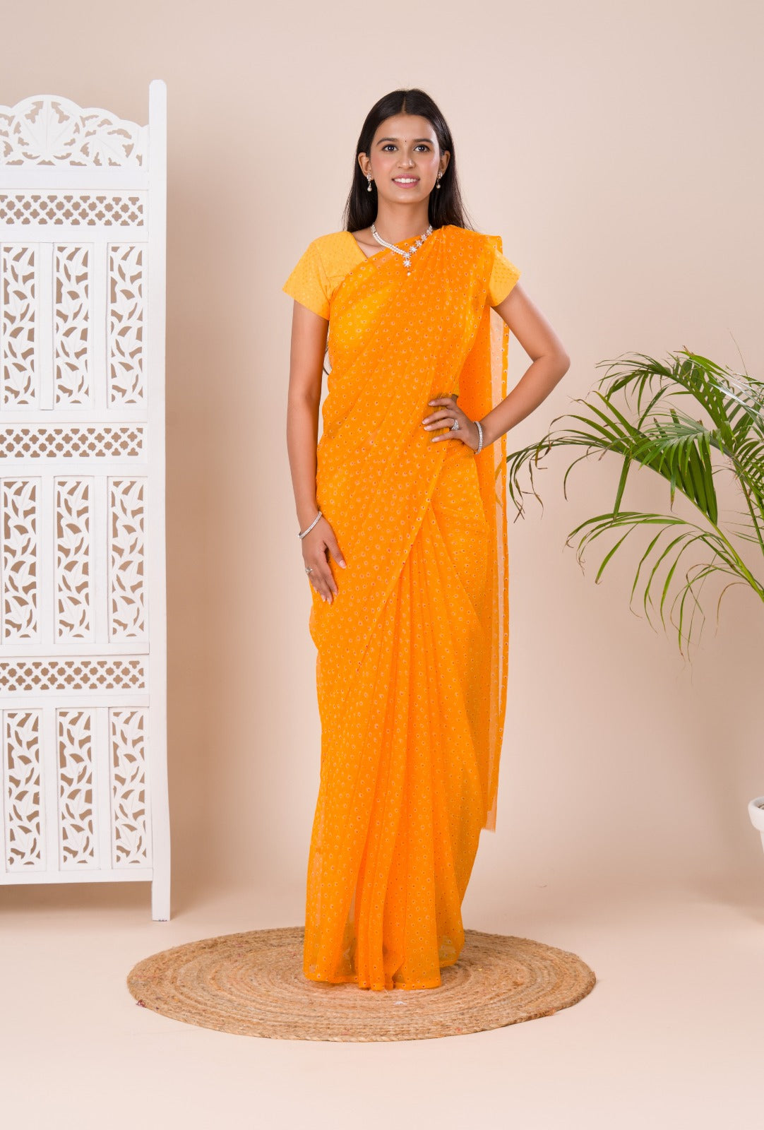 A yellow chiffon saree with a bandhani pattern 