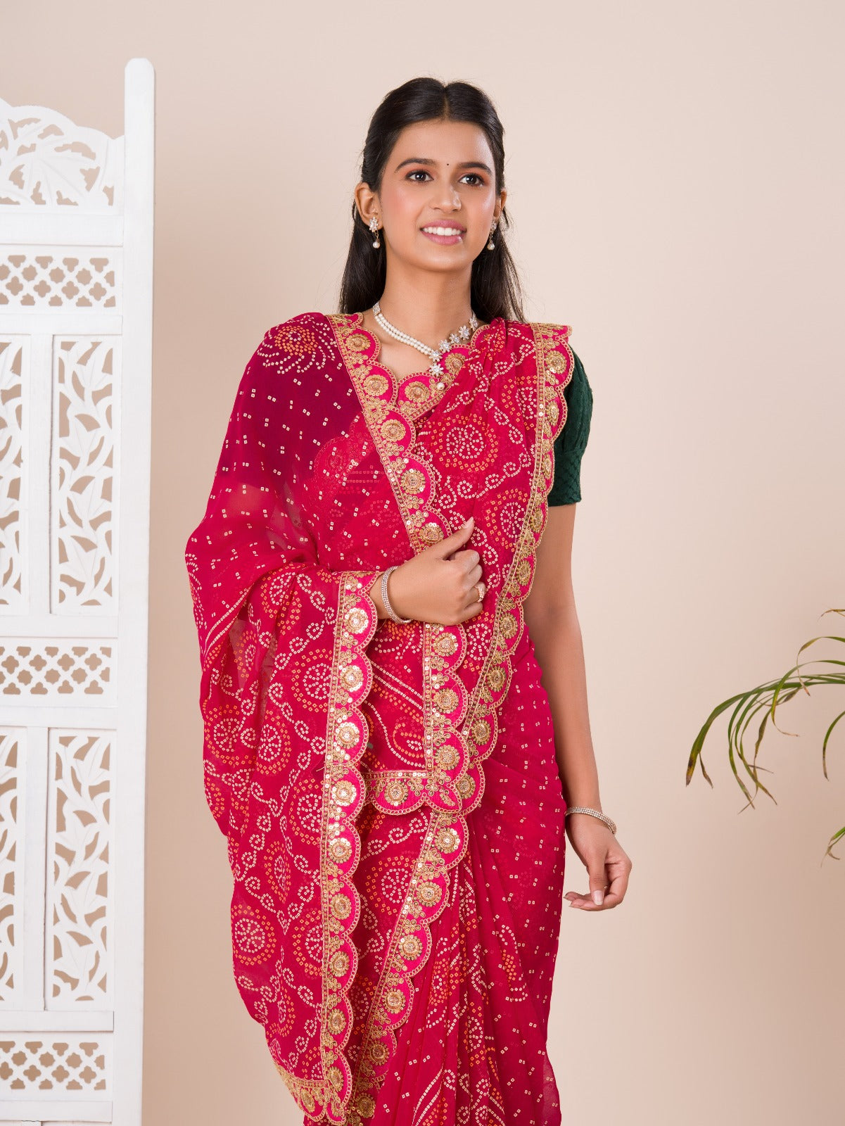 Ared and pink bandhani style saree with gotapatti embellishments and a mangal patha design