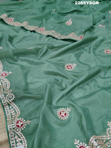 A green saree with tissue silk texture and Gotapatti work embroidery.