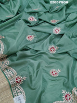 A green saree with tissue silk texture and Gotapatti work embroidery.