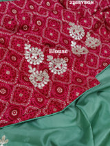 A green saree with tissue silk texture and Gotapatti work embroidery.