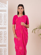 A pink saree with bandhani pattern and aari tari work