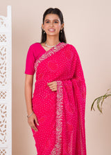 A pink saree with a bandhani pattern 