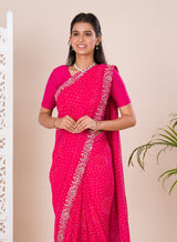 A pink saree with a bandhani pattern 