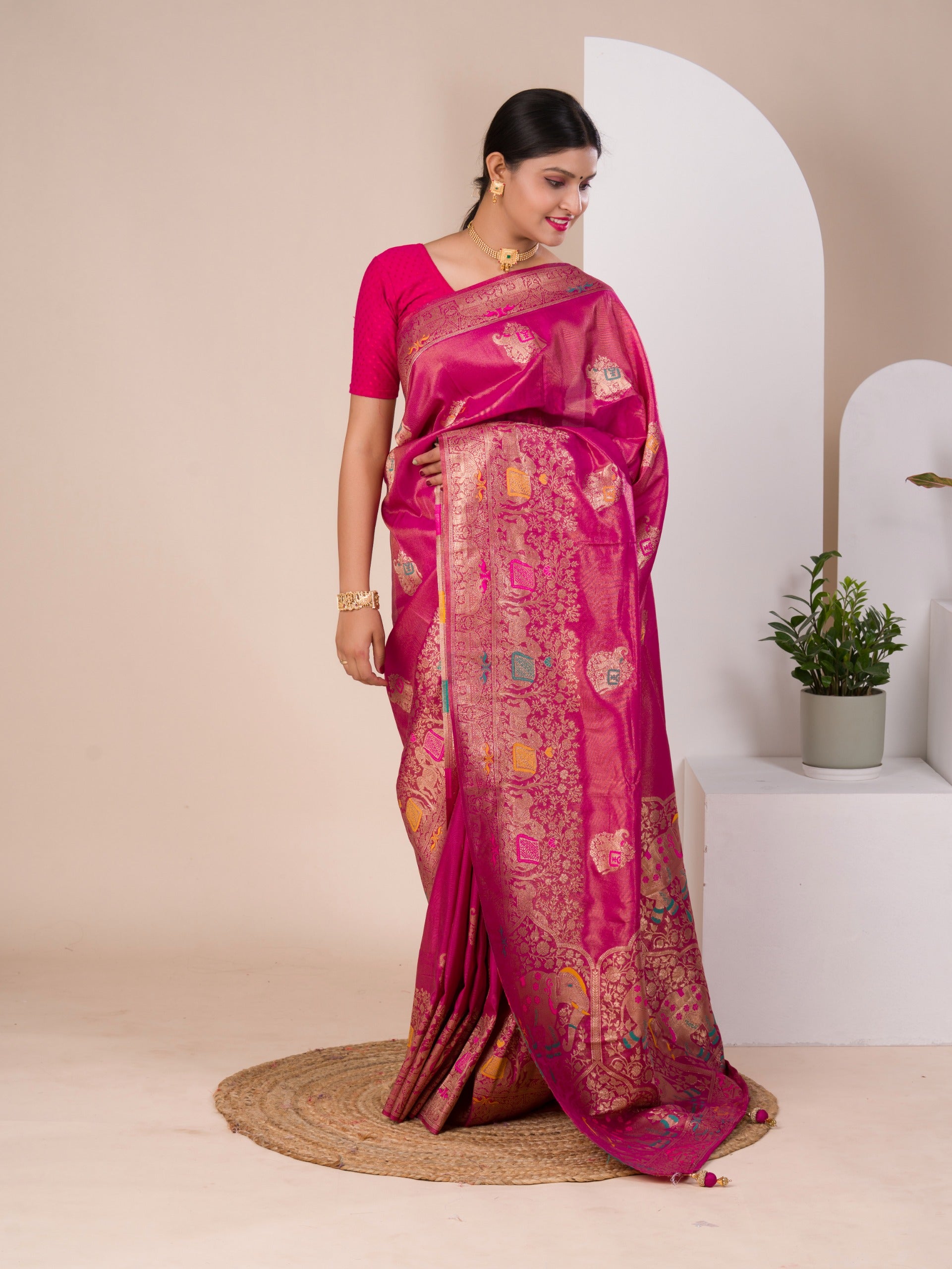 A pink Banarasi style saree with Meenakari weaving, 