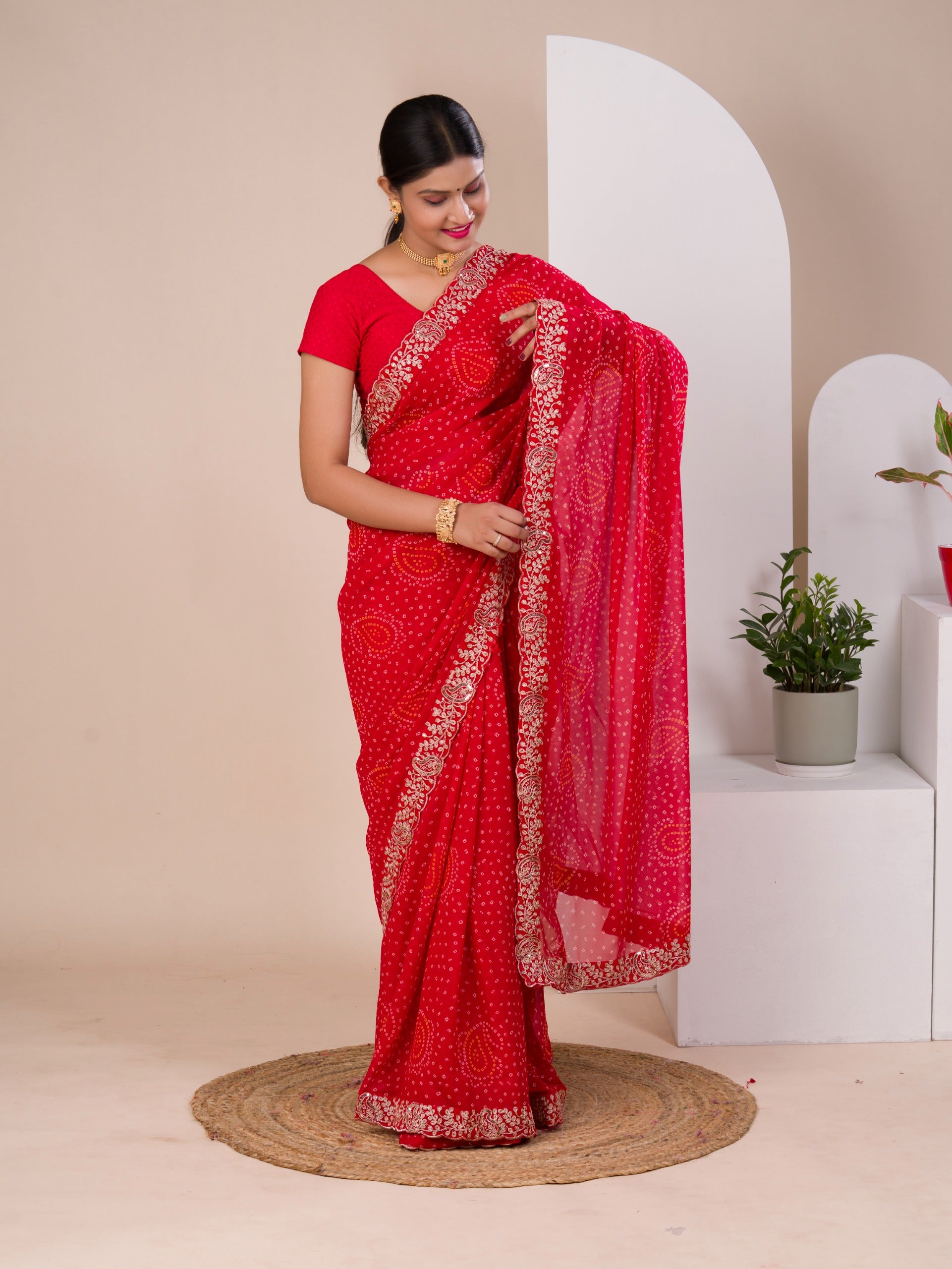 A red chiffon saree with bandhani pattern 