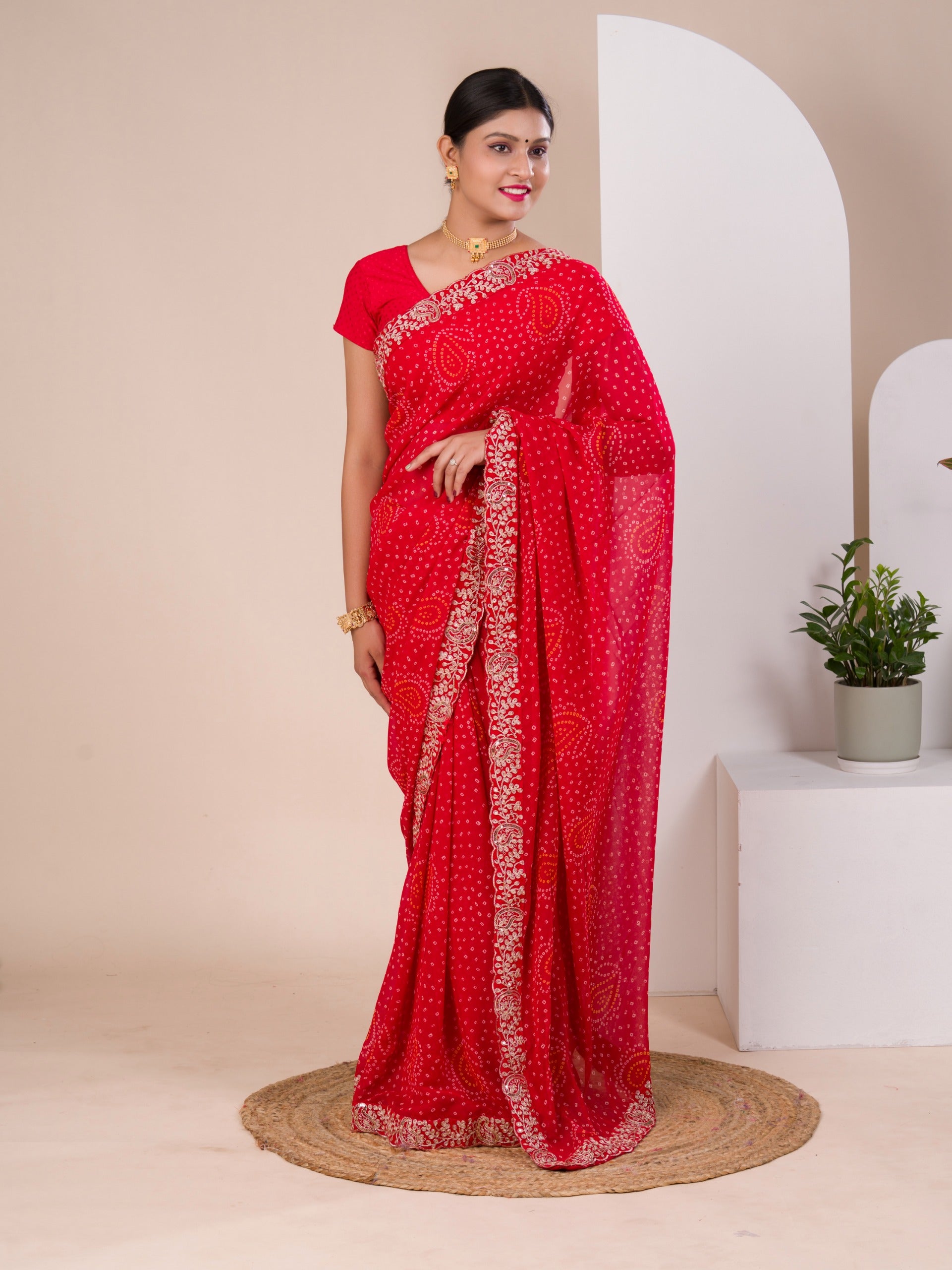 A red chiffon saree with bandhani pattern 