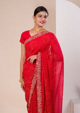 A red chiffon saree with bandhani pattern 