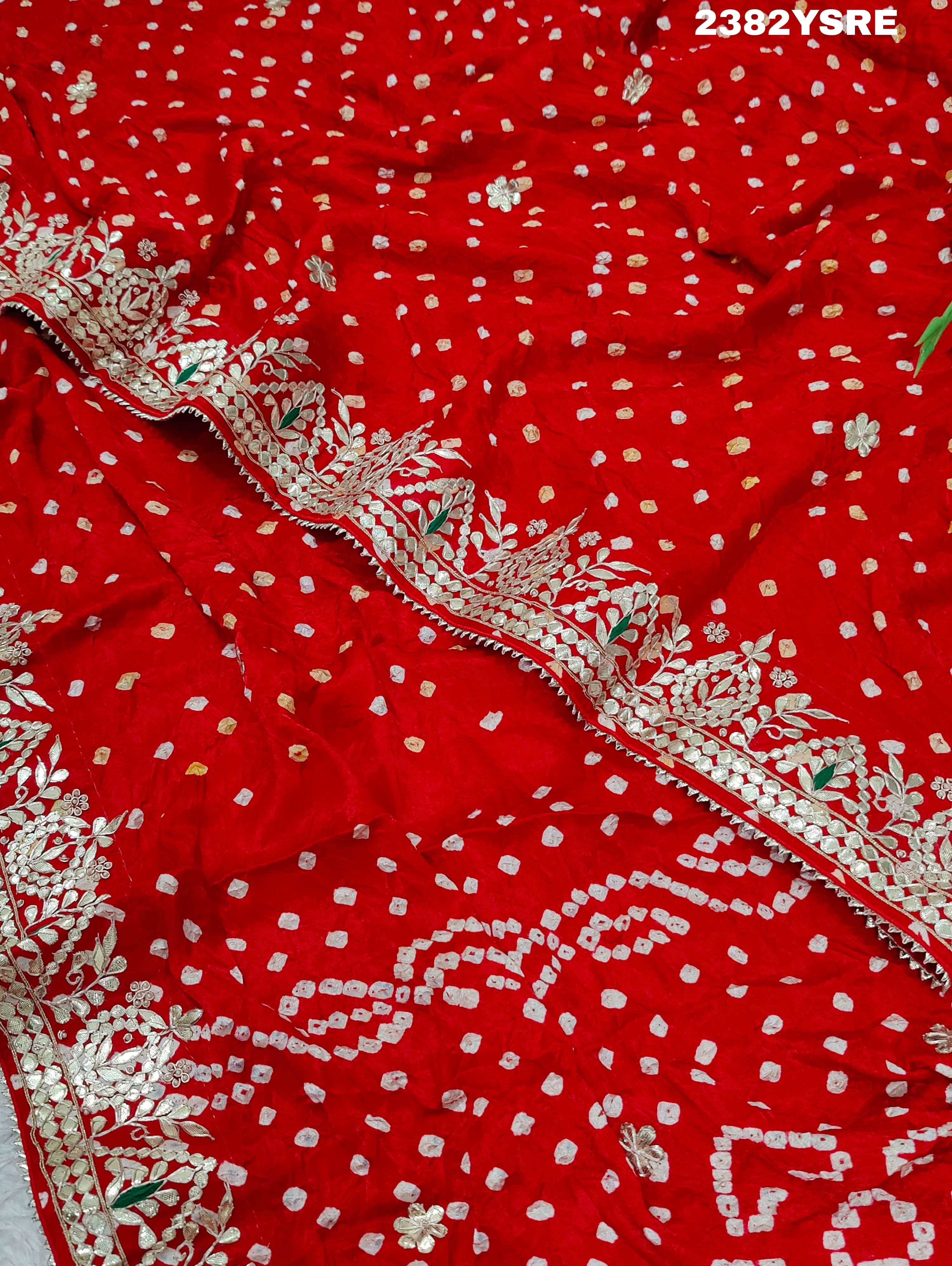 A red saree with white bandhani (dot) pattern and gotapatti border, 