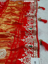 A red saree with white bandhani (dot) pattern and gotapatti border, 